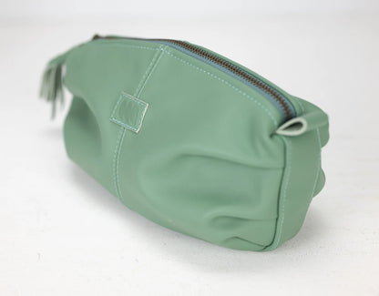 Green toiletry bag with a zipper on a white background