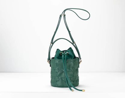 Green leather bucket bag with drawstring on a white background