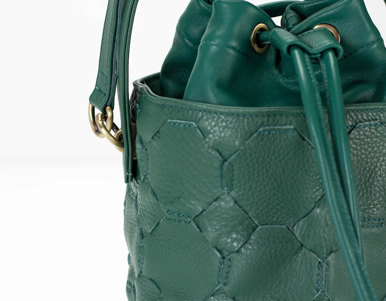 Green textured handbag with drawstring on a white background