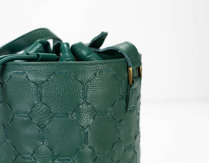 Green textured handbag on a white background