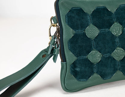 Green handbag with geometric pattern on a white background