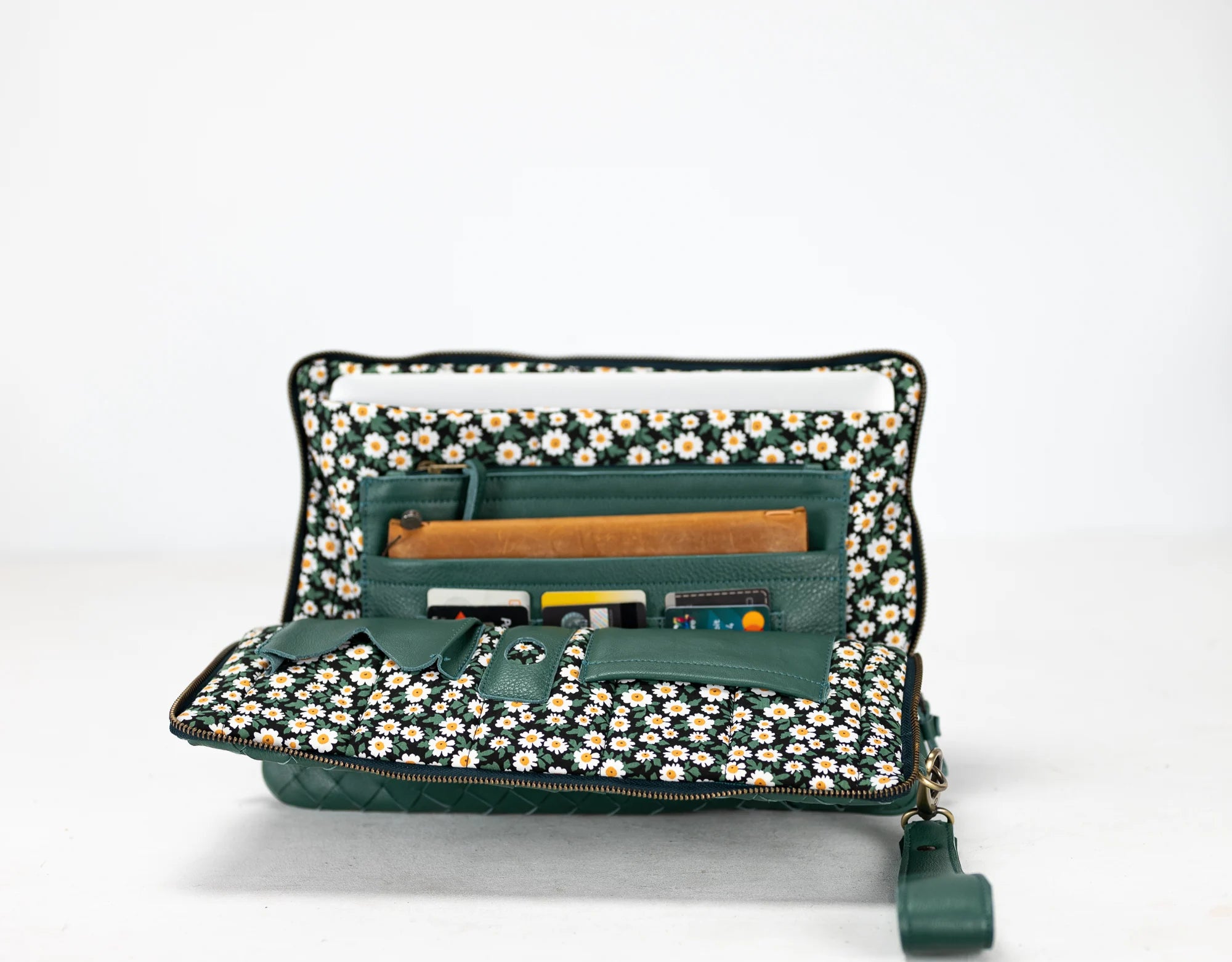 Green travel organizer with floral pattern on a white background