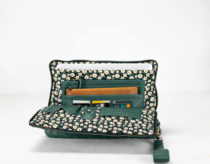 Green travel organizer with floral pattern on a white background