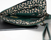 Green handbag with floral pattern on a white background