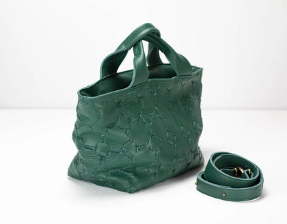 Green textured handbag with matching strap on a white background