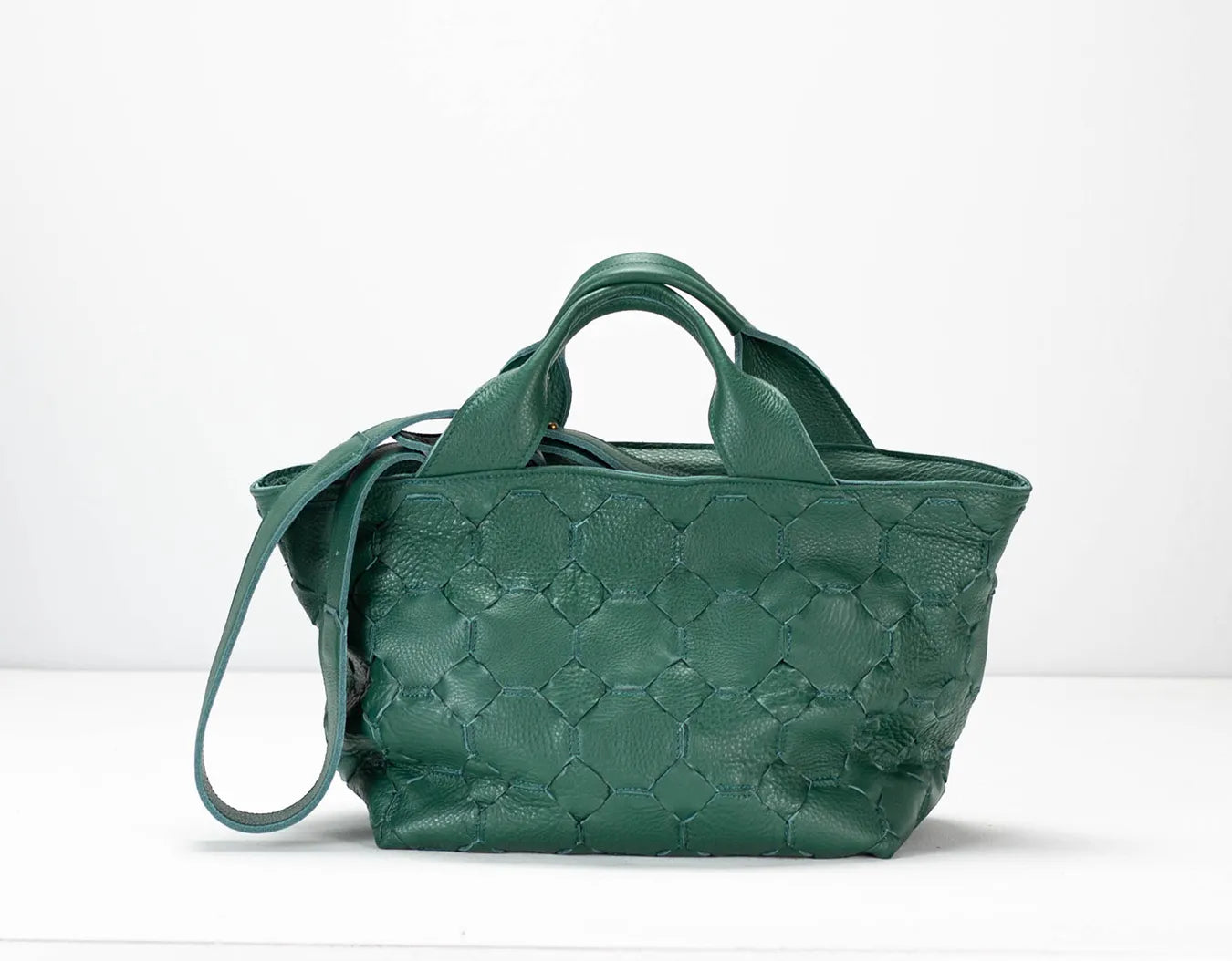 Green textured handbag on a white background