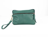 Green leather clutch bag with a wrist strap on a white background