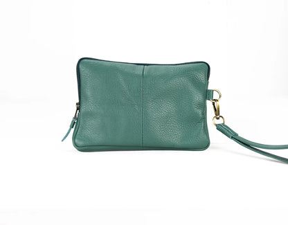 Green leather clutch bag with a strap on a white background