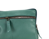 Green leather bag with zipper on a white background
