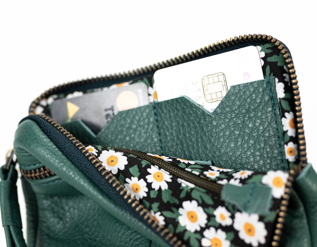 Green floral-patterned wallet with cards inside on a white background