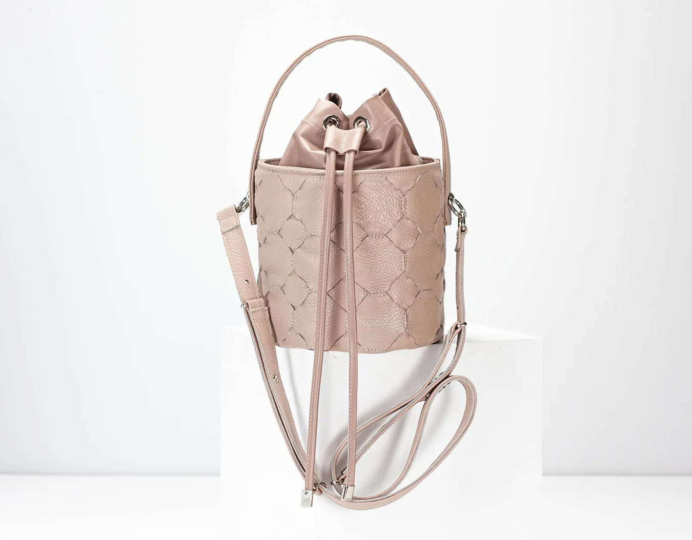 powder pink quilted backpack on a white background