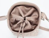 Beige handbag with a bow detail on a white background