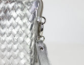 Silver woven clutch bag with a zipper on a white background
