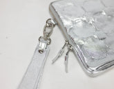 Silver wallet with strap and keychain on a white background