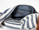 Open striped bag with visible brand logo on a light gray background
