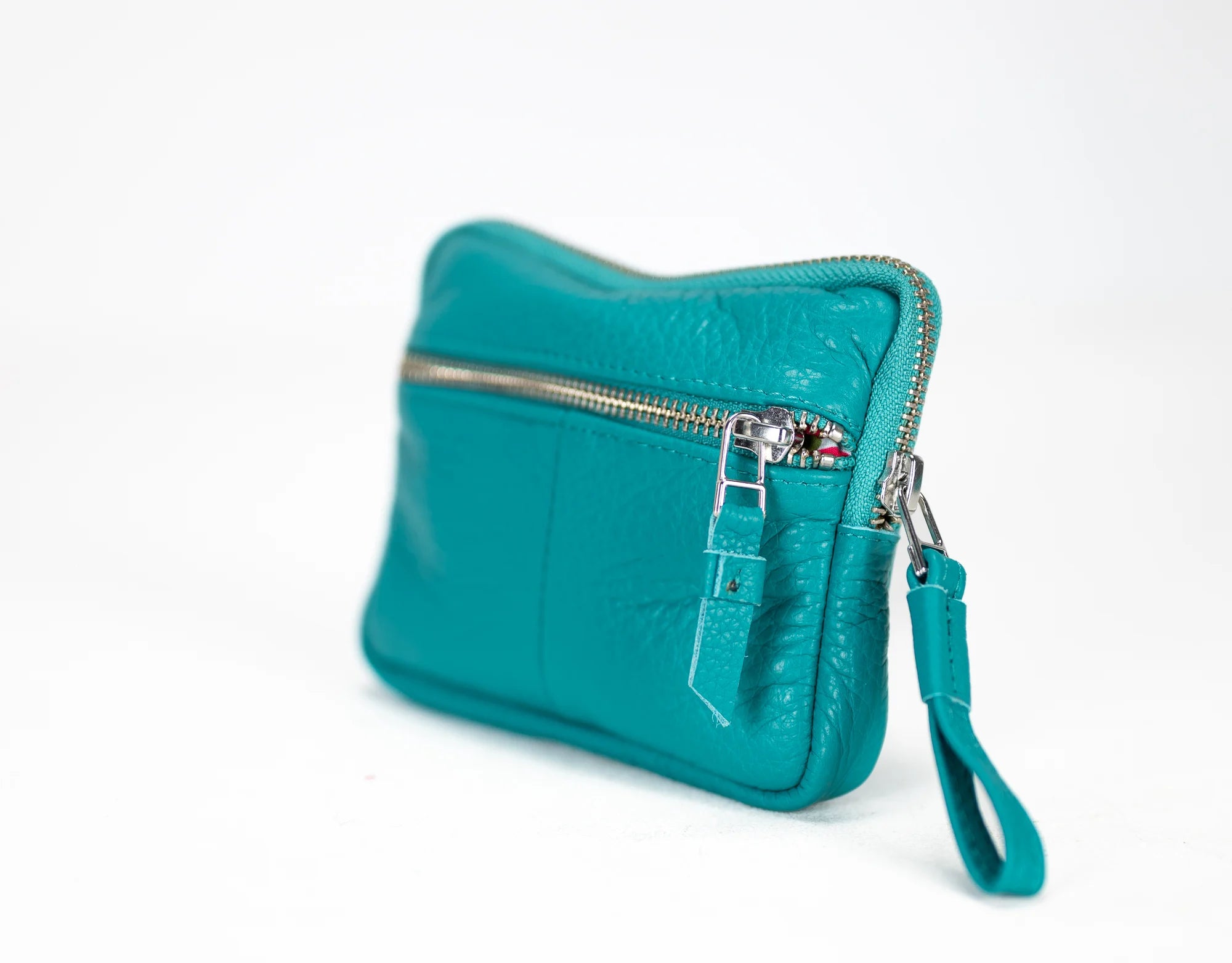 Turquoise handbag with a silver zipper on a white background