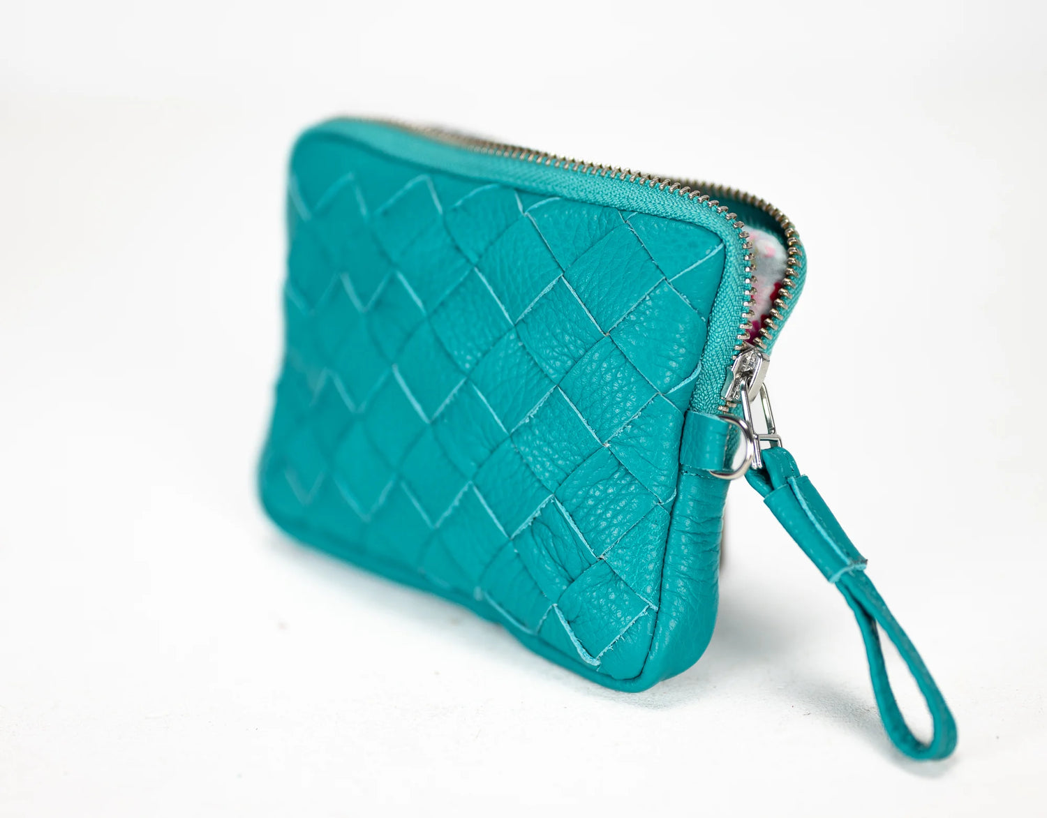 Teal quilted clutch with a strap on a white background