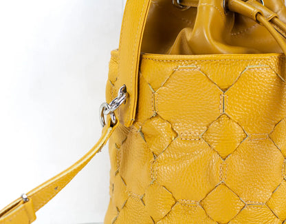 Yellow textured handbag on a white backgroundy