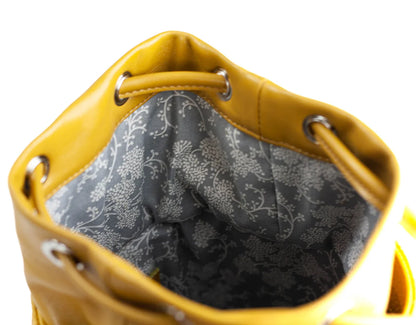 Yellow handbag with floral patterned interior on a white backgroundy