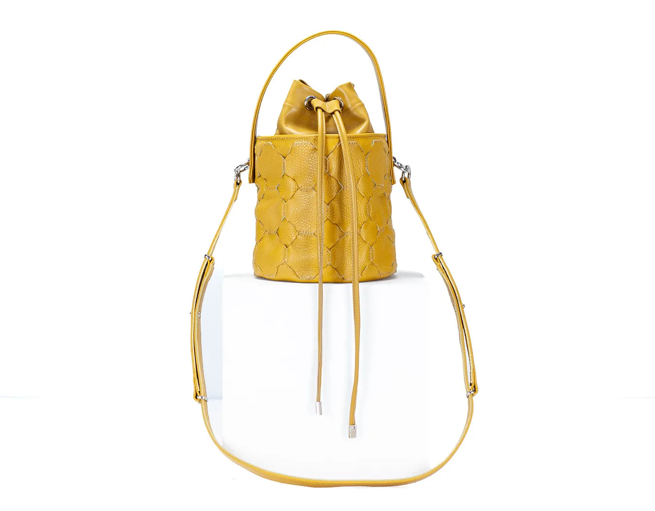 Yellow handbag with floral patterned interior on a white backgroundy