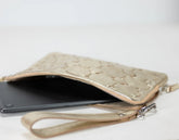 Yellow gold quilted clutch bag with a phone and cards on a white background