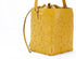 Yellow textured handbag on a white background