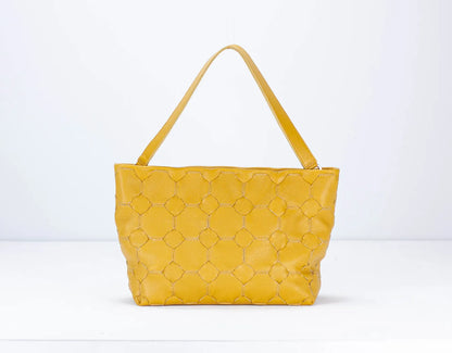 Yellow quilted handbag on a white background
