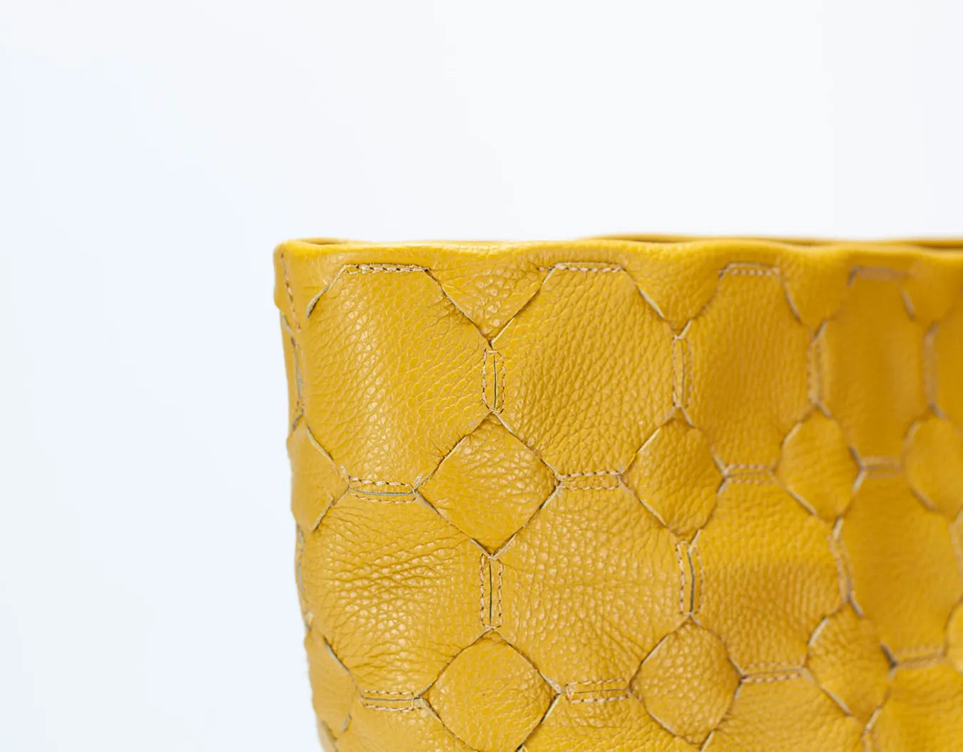 Yellow woven clutch bag on a white background