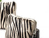 Zebra-patterned handbag with a visible zipper on a white background