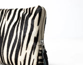 Zebra-patterned pouch with a zipper on a white background