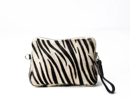 Zebra patterned pouch with a strap on a white background