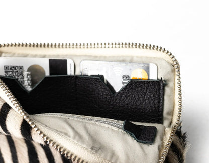 Close-up of a zipped pouch with black interior pocket on a white background