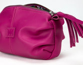 Pink handbag with a tassel on a white background