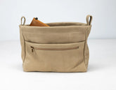 Beige leather bag with a zipper pocket on a white background