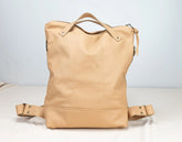 Beige leather backpack on a light gray background