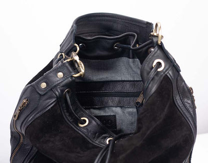 Black leather bag with gold hardware on a white background