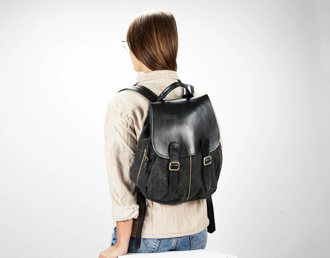 Person wearing a black backpack on a white background