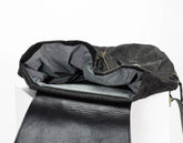 Black leather bag with a gray interior on a white background