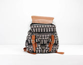 Patterned backpack with brown straps on a white background