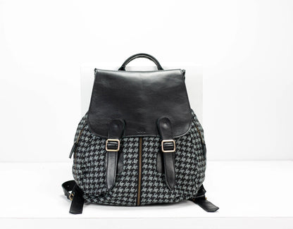 Black and gray checkered backpack with leather straps on a white background