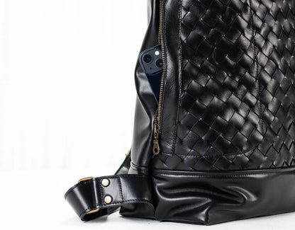 Black woven leather bag with a white background