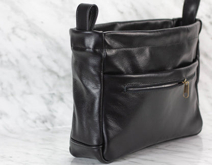 Black leather purse insert with a zipper on a light background