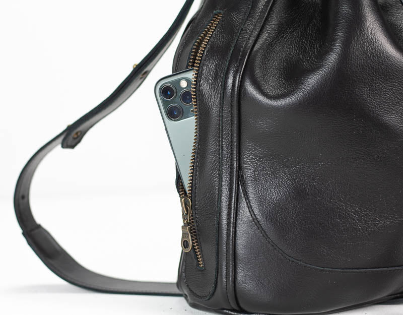 Black leather bag with a zipper on a white background