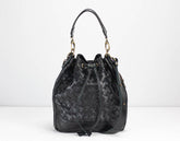 Black woven handbag on a white background