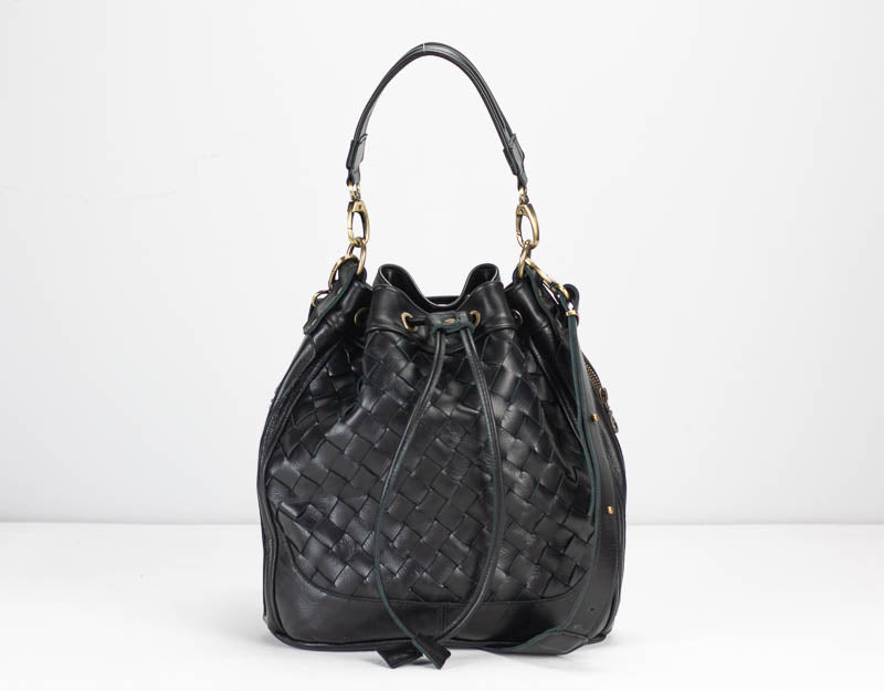 Black woven handbag on a white background