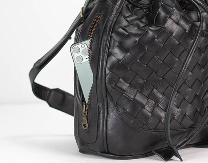 Black woven leather backpack with a phone pocket on a white background