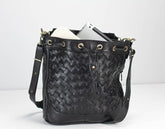 Black woven handbag with a white background
