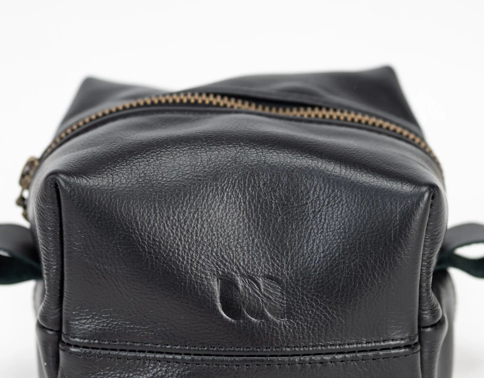 Black leather pouch with a zipper on a light background#color_black
