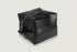 Black leather toiletry bag with gold zipper on a white background