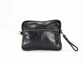 Black leather clutch with gold zipper on a white background